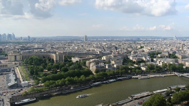 Aerial view of paris showing the river seine, jardins du trocad&eacute;ro, and the palais de chaillot with tourist boats sailing and the cityscape stretching to the horizon