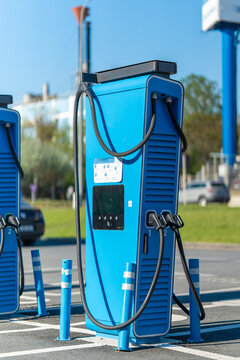 Blue charging station stands ready for electric vehicles