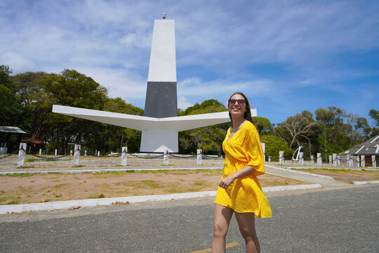 Young woman with sunglasses walking near Cabo Branco Lighthouse in Joao Pessoa the easternmost point of the American continent, Brazil