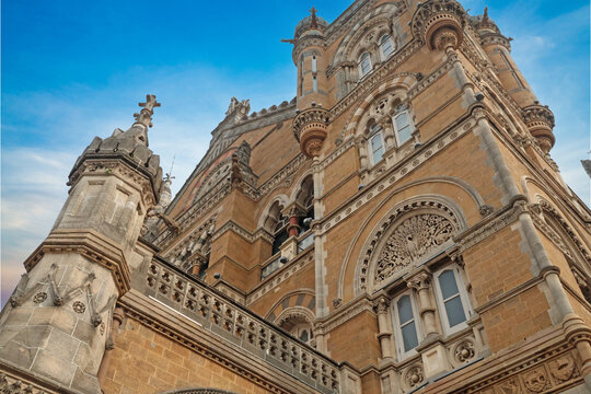 Mumbai Maharashtra India Jan 18 2026 Low angle architectural view of the ornate stone facade and soaring towers of Chhatrapati Shivaji Maharaj Terminus against a clear blue sky.