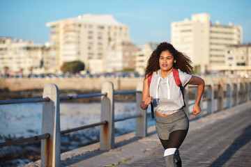 Fitness, running or woman with exercise on boardwalk, endurance training or cardio routine for...