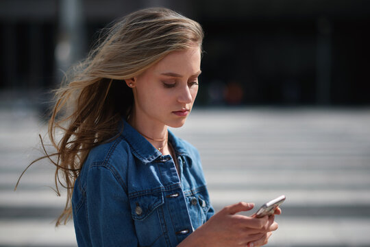 Outdoor, student and woman with phone for commute, reading message and university app for schedule. City, morning travel and scholar with mobile for directions, digital navigation and check location