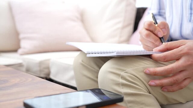 Professional reviewing information and writing notes for research and analysis. Knowledge management, strategic thinking, decision making and business development concept.