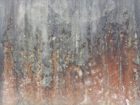 Metal sheet texture covered in heavy dripping rust and dark oxidation lines creating an industrial grunge pattern