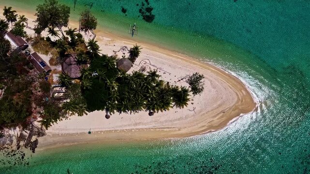 Breathtaking wide drone shot over Port Barton, Palawan, Philippines. Features a chain of lush green tropical islands surrounded by spectacular turquoise coral reefs and deep blue ocean waters.