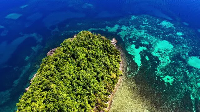 Breathtaking wide drone shot over Port Barton, Palawan, Philippines. Features a chain of lush green tropical islands surrounded by spectacular turquoise coral reefs and deep blue ocean waters.