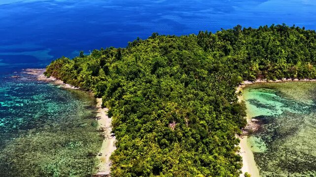 Breathtaking wide drone shot over Port Barton, Palawan, Philippines. Features a chain of lush green tropical islands surrounded by spectacular turquoise coral reefs and deep blue ocean waters.
