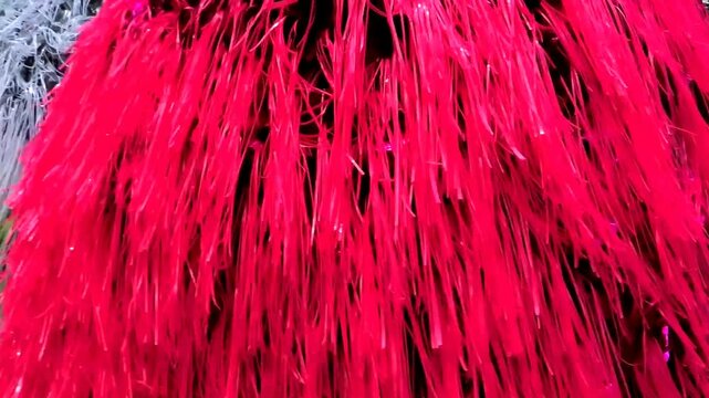 Spinning crafted tinsel bit decorative towers accompanied in the procession during a temple festival in South India