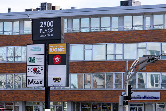Gaspesie, Canada, 30 May 2026 : A multi-tenant commercial building features a prominent sign displaying various businesses and their names.