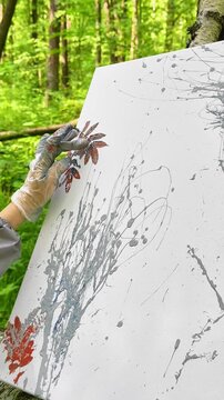 Gloved Hand Pressing Red Leaf onto Canvas for Botanical Imprint. Fusion of nature and abstraction - a therapeutic, beginner-friendly process rooted in plein air creativity.
