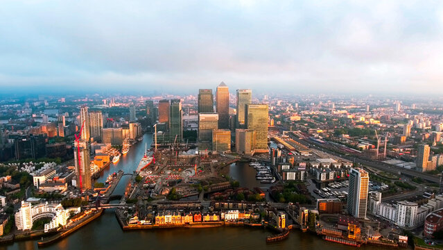 Aerial drone view of Canary Wharf financial district, One Canada Square, HSBC and Barclays towers, West India Docks, Isle of Dogs, London, dawn