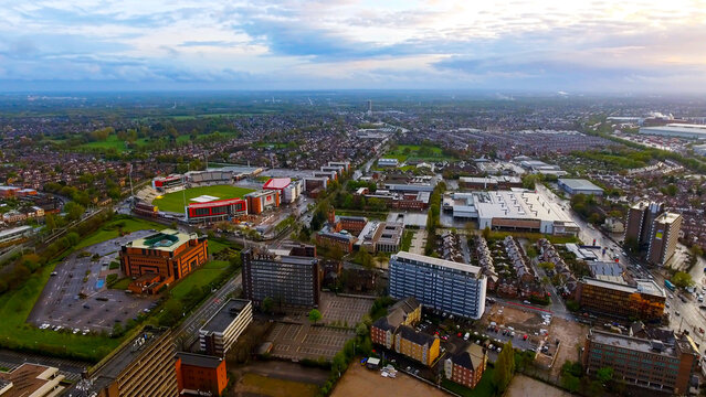Aerial drone view of Emirates Old Trafford cricket ground, Lancashire CCC, with Stretford and Greater Manchester suburban cityscape, Old Trafford, spring