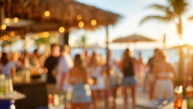 blurred group of man and woman socializing at tropical beach bar during golden sunset. Friends enjoying summer vacation lifestyle at outdoor restaurant. Leisure travel holiday concept.