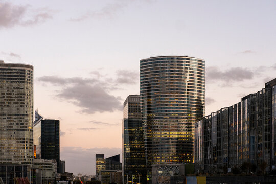 Dusk skyline in Paris, France layers tower architecture, glass facade, business district and office lights across La Defense with evening urban depth