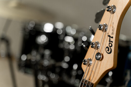 Music creation moment with a Cort bass guitar and drum set in the studio