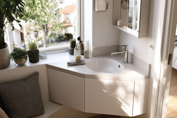 Fototapeta premium Capture elegance in a contemporary bathroom featuring a stylish vanity, enhancing personal spaces with its sleek design and effective use of natural light and materials.