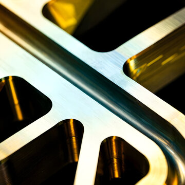Macro shot focusing on the micro-texture grain boundaries and material entropy of forged beryllium track sprint-blocks. 