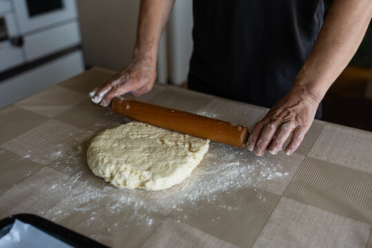 The housewife kneads and makes the scones in the traditional way according to an old recipe.