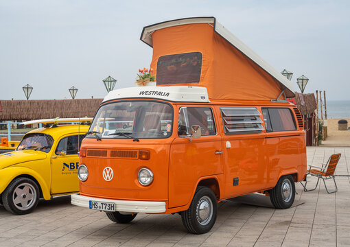 Scheveningen, The Netherlands, 31.05.2026, Orange VW Kombi Camper Van with rooftop tent displayed at the beach during the classic car show