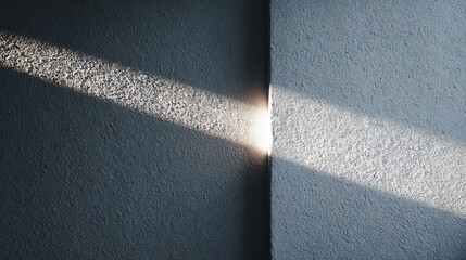 Fototapeta premium Sunlight Beam Illuminates Textured Wall Corner in Soft Light