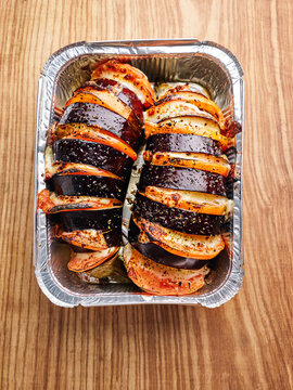 Grilled eggplant and squash with seasoning, BBQ feast preparation, summer gathering concept