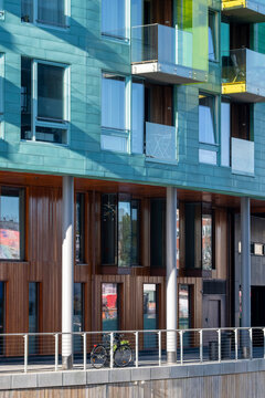 Colorful apartment facade in Oslo, Norway layers windows, balconies, glass, residential architecture and urban housing above a street edge