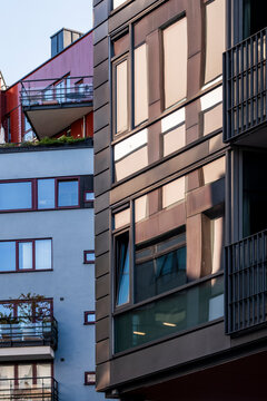 Apartment buildings in Oslo, Norway align facades, balconies, windows, residential architecture and urban housing layers in warm light
