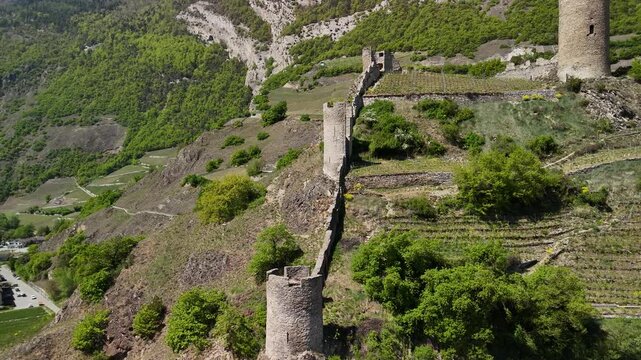 Saillon Castle ruins Bayard Tower Valais valley Switzerland landmark, aerial drone landscape video