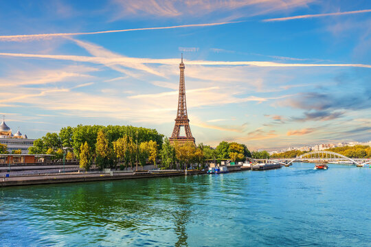 Epic Paris sunset view of Eiffel Tower across Seine River with historic bridges, Paris, France
