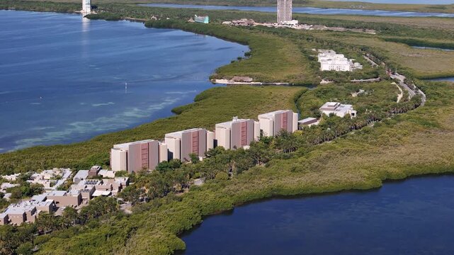 Drone Shot of Modern Hotels in Cancun Mexico, Green Landscape Between Lagoon and Caribbean Sea