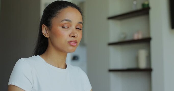 Portrait of a sporty woman looking at the camera resting after training at home. Beautiful healthy sportive girl athlete resting after intense hard training.
