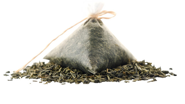 Pyramid-shaped green tea bag with dried herbal leaves visible, healthy lifestyle beverage, isolated on white background