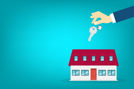 Hand holding key over the house. House buying	