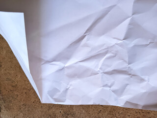 Obraz premium abstract texture of a heavily crumpled sheet of paper, featuring complex folds, deep creases, and soft geometric shadows