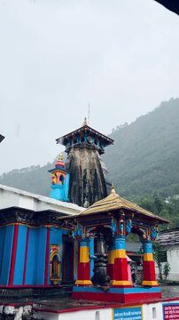Ancient Omkareshwar Temple in Ukhimath, Uttarakhand, India, featuring traditional Himalayan architecture against misty mountain slopes, a revered winter seat of Lord Kedarnath.
