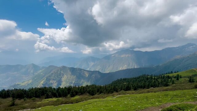 Dark monsoon clouds gathering over the Himalayan mountain ranges, creating a dramatic landscape filled with natural beauty and changing weather.