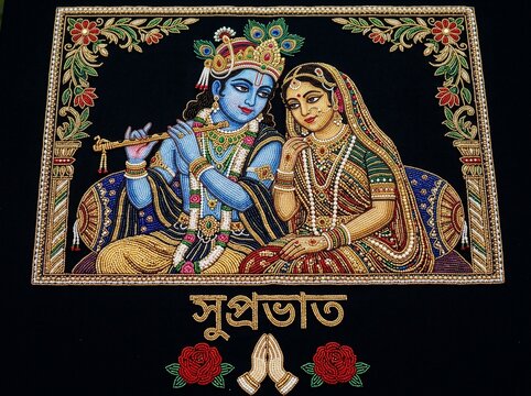 Hindu deity Krishna and Radha in traditional attire with flute and jewelry