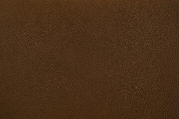 Fototapeta premium Rich brown leather surface detail with subtle highlights for background applications