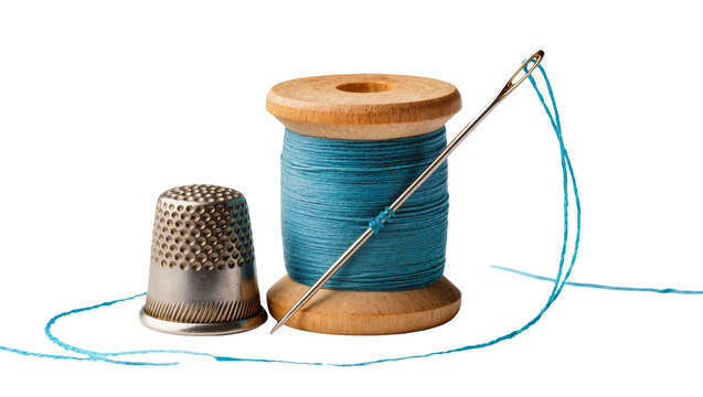 Wooden spool of blue thread with needle and thimble