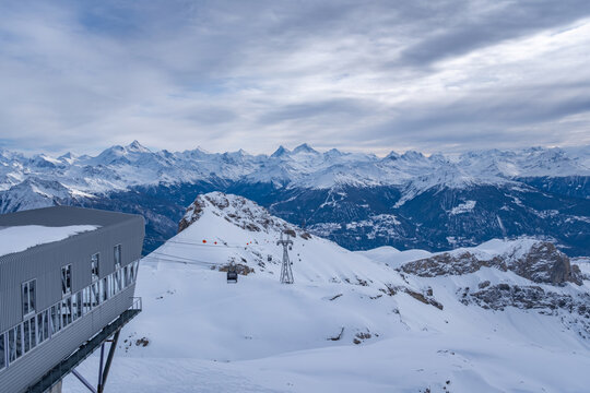 Scenic view from top station of Funitel Violettes-Plaine Morte in Crans-Montana, Switzerland over Rhone Valley towards Weisshorn and Matterhorn against cloudy sky