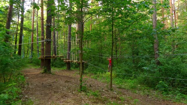 Small girls with helmet in adventure park