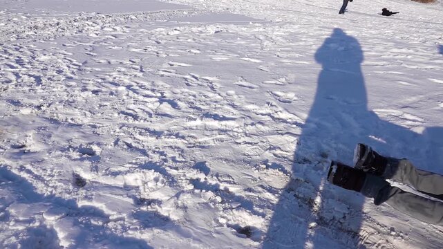 Beautiful little girl goes down on an inflatable snow tubes down the winter snow-covered hill.
