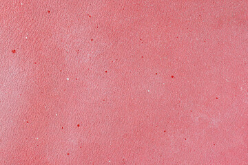 Fototapeta premium Pink textured background with fine red and white splatters