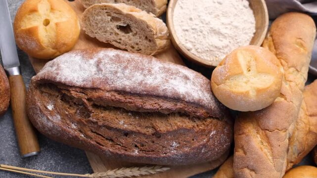 Freshly baked bread assortment with flour and wheat