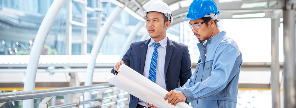 Banner Contractor construction engineer meeting on architect table at construction site. Businessman engineer manager discuss talk together foreman team builder using measure tape with copy space.