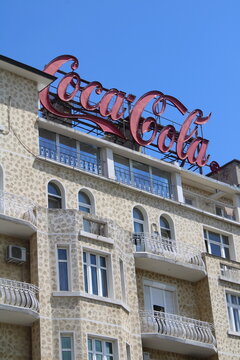 Sofia, Bulgaria - May 25, 2026: Advertisement for the company Coca-Cola on the rooftop of a historic buliding downtown Sofia, Bulgaria, Europe.