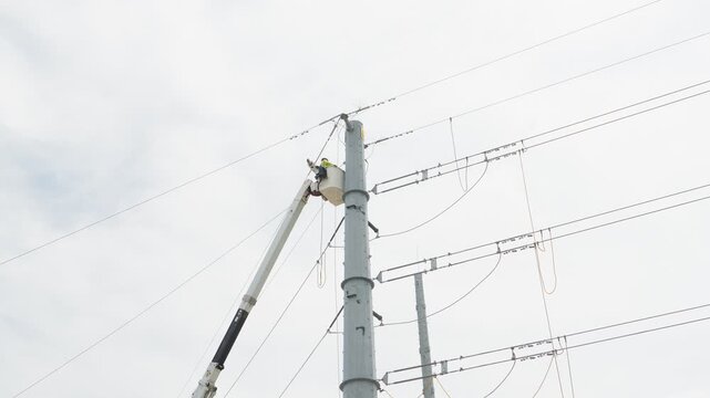 Electrical power linemen in bucket lift