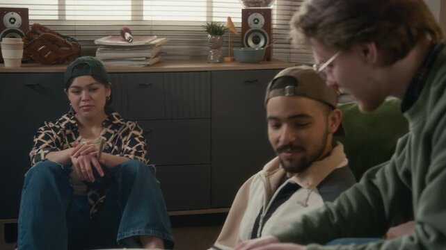 Multiethnic young college students calculating expenses and discussing household utility bills at home. Video is perfect for financial planning, student debt, and budgeting app promotions