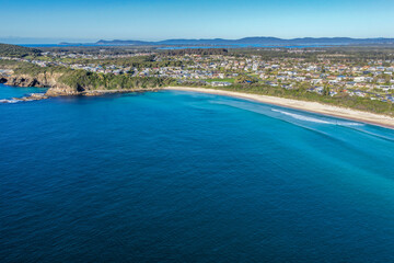Naklejka premium Aerial scene capturing One Mile Beach near Forster, NSW, Australia, with the residential areas of Forster visible in the background. The expansive sandy shoreline, Pacific Ocean and surrounding coast.
