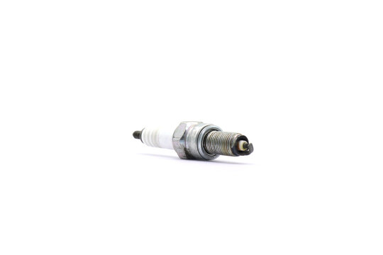 A spark plug on a white background is a crucial component in the ignition system of a gasoline engine.